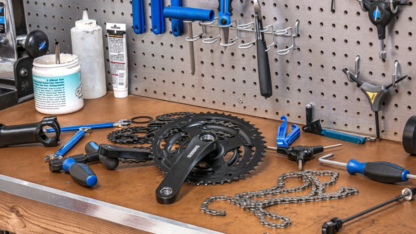 how to buy a bike online might start with learning how to assemble it. Here's some bike parts on a work bench.